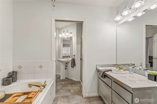 a bathroom with a tub sink and shower