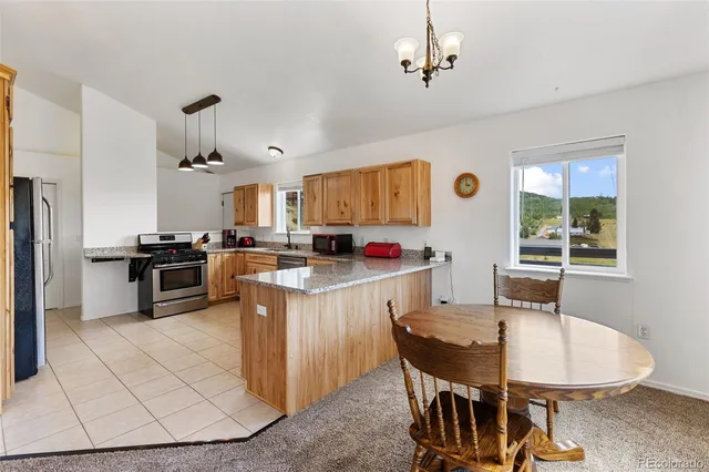 a kitchen with a sink stove top oven and cabinets
