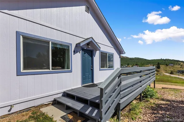 a view of a house with pool and sitting area