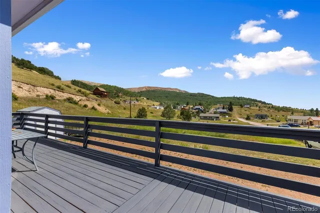 a view of a house with a yard and sitting area