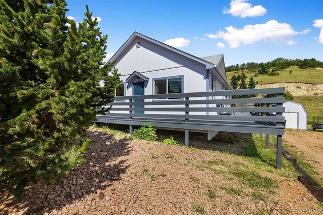 a view of a house with backyard and sitting area