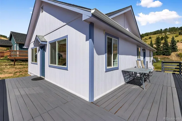 a view of a wooden chairs on the deck