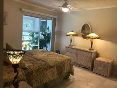 a bed sitting in a bedroom next to a window