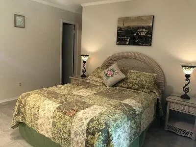 a large bed sitting in a bedroom next to a window