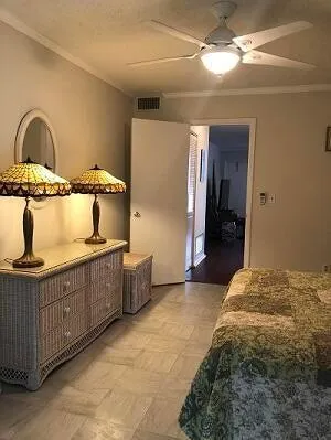 a bedroom with bed and cabinets