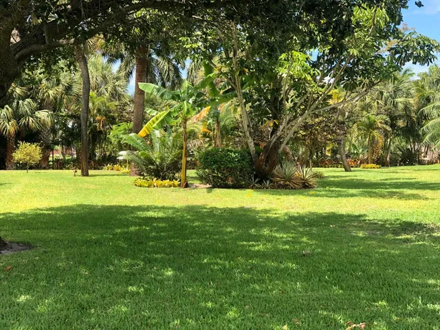 a view of the patio with dining table and chairs and a fire pit