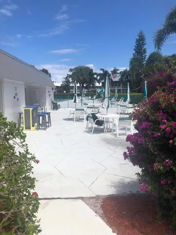 a view of a patio with a table and chairs