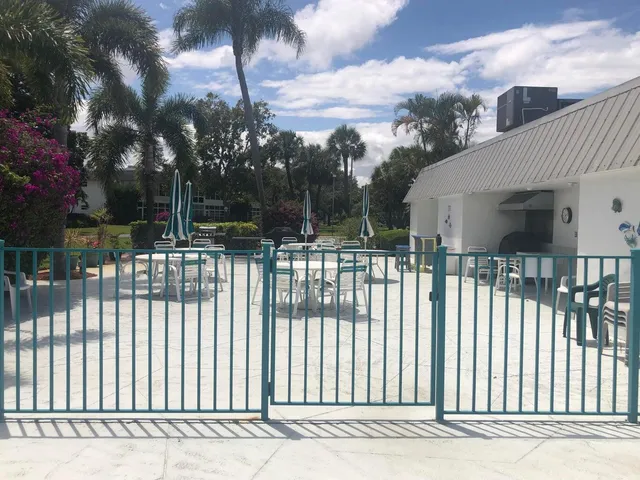 a view of a swimming pool with a patio and a garden