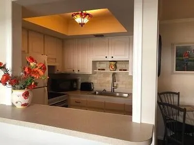 a kitchen with stainless steel appliances granite countertop a refrigerator and a stove