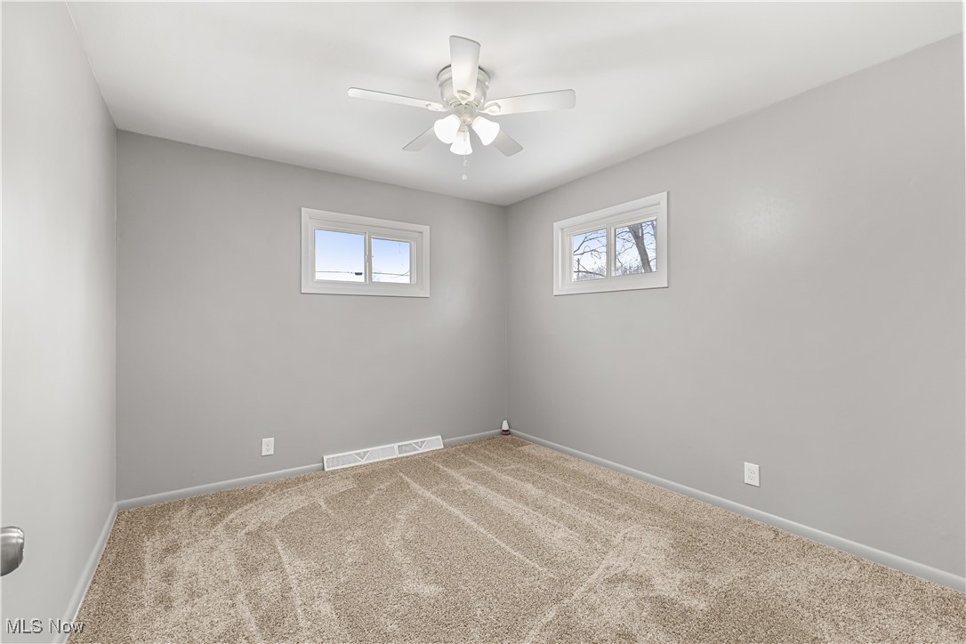 6161 Shaffer Road Northwest Warren, OH 44481 - Photo 15 of 20 Empty room with carpet flooring and ceiling fan