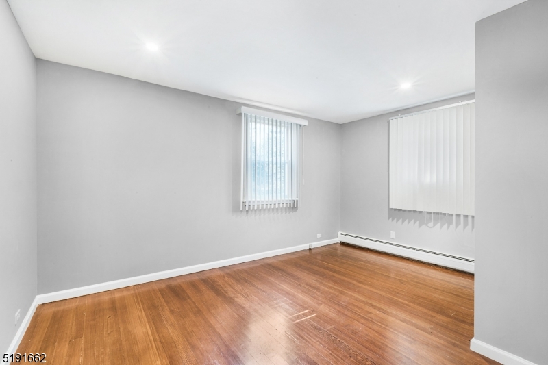 27 Hillcrest Road Warren, NJ 07059 - Photo 14 of 25 a view of empty room with wooden floor and fan