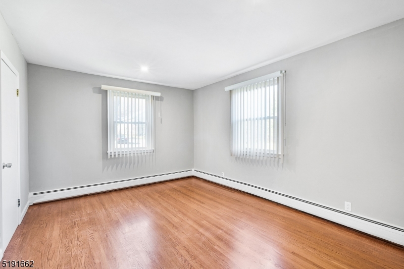 27 Hillcrest Road Warren, NJ 07059 - Photo 16 of 25 an empty room with wooden floor and windows