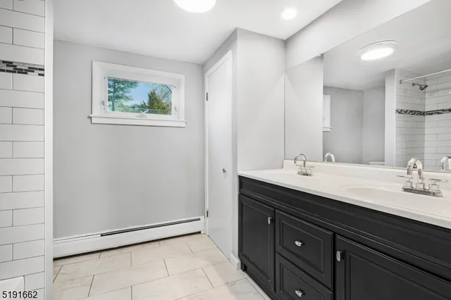a bathroom with a double vanity sink and mirror