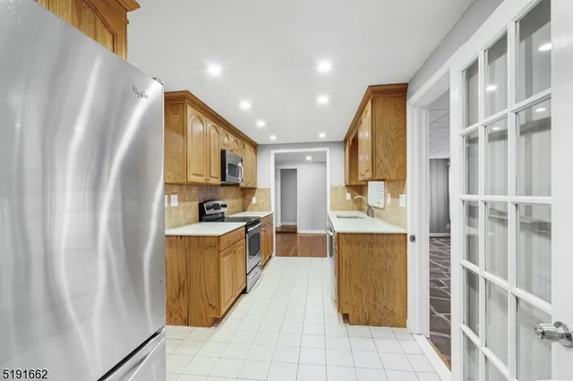 a kitchen with stainless steel appliances granite countertop a refrigerator and a stove