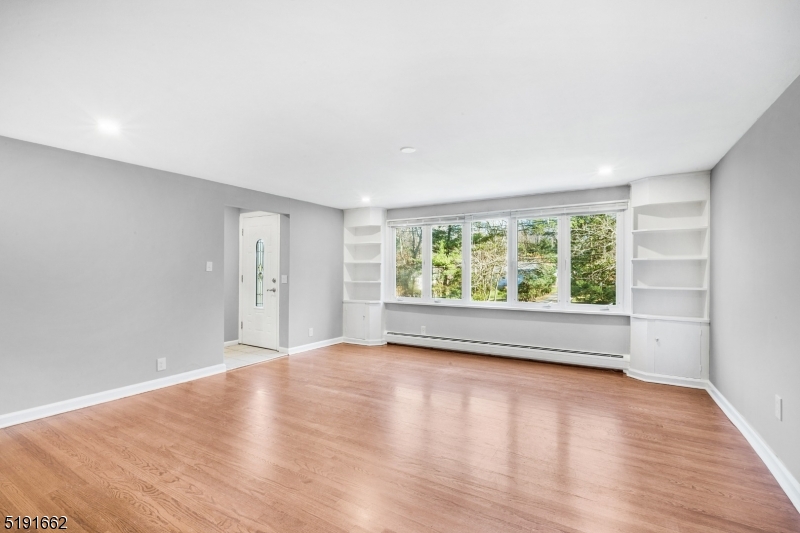 27 Hillcrest Road Warren, NJ 07059 - Photo 8 of 25 wooden floor in an empty room with a window