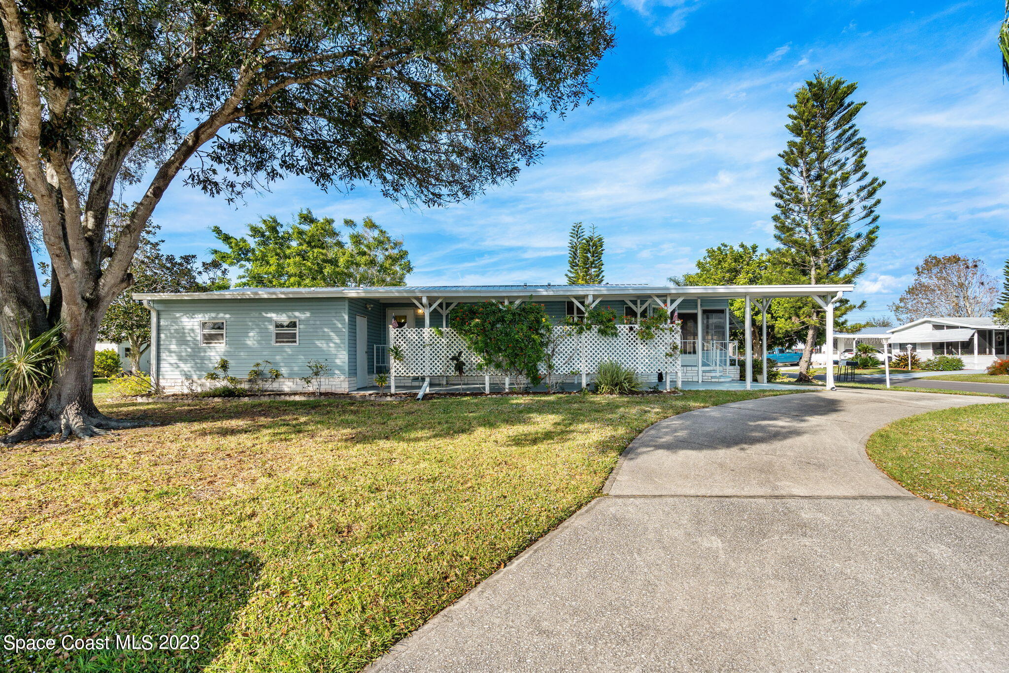 701 Gladiolus Drive Barefoot Bay, FL 32976 - Photo 14 of 19 a front view of a house with garden