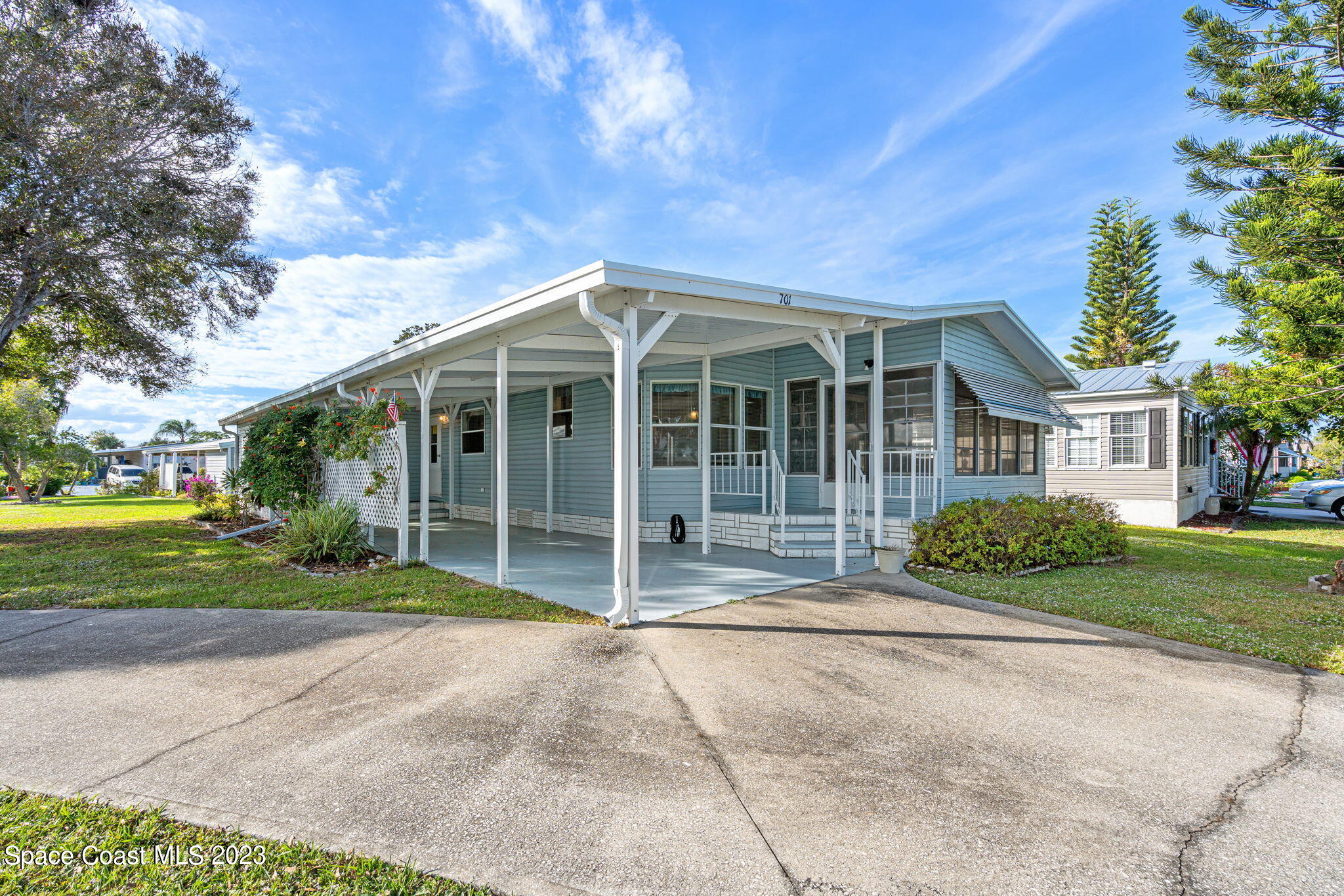 701 Gladiolus Drive Barefoot Bay, FL 32976 - Photo 15 of 19 a front view of a house with garden