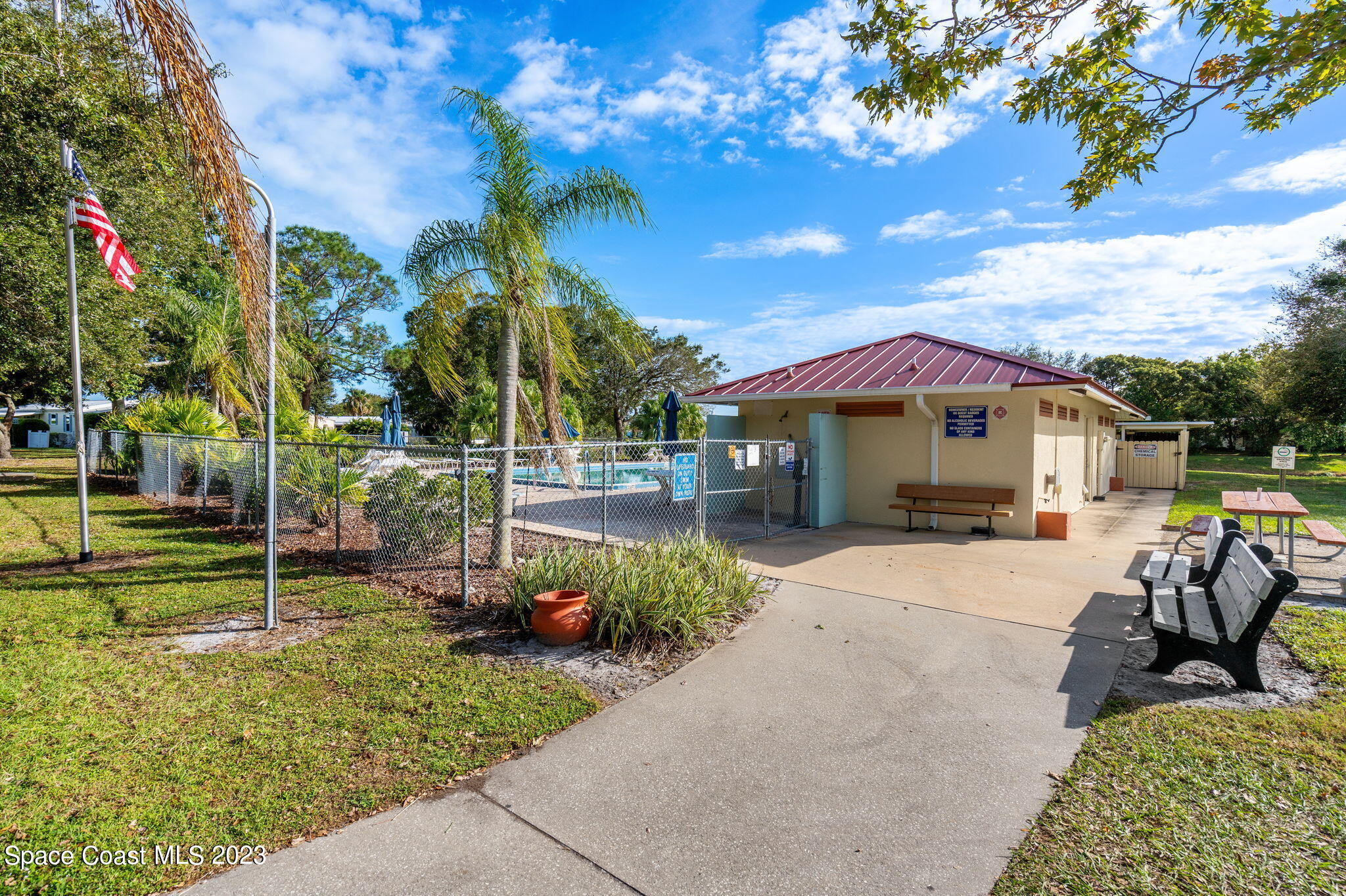 701 Gladiolus Drive Barefoot Bay, FL 32976 - Photo 17 of 19 a view of a house with backyard and sitting area