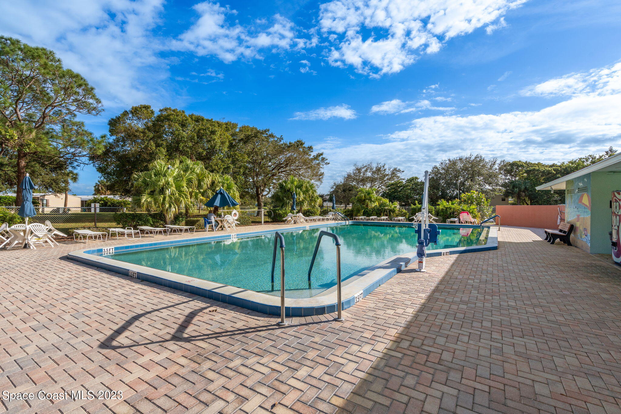 701 Gladiolus Drive Barefoot Bay, FL 32976 - Photo 18 of 19 a view of a backyard
