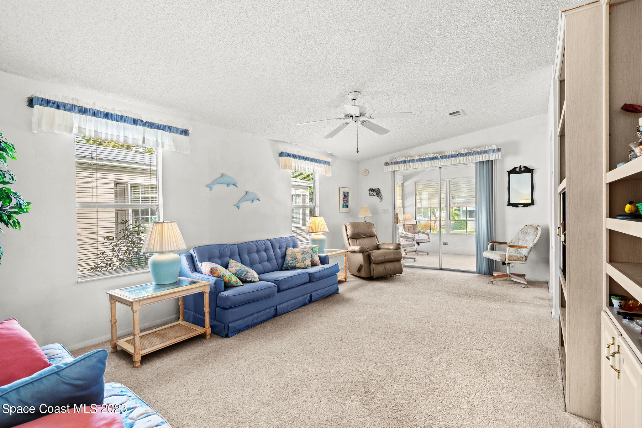 701 Gladiolus Drive Barefoot Bay, FL 32976 - Photo 3 of 19 a living room with furniture and a large window