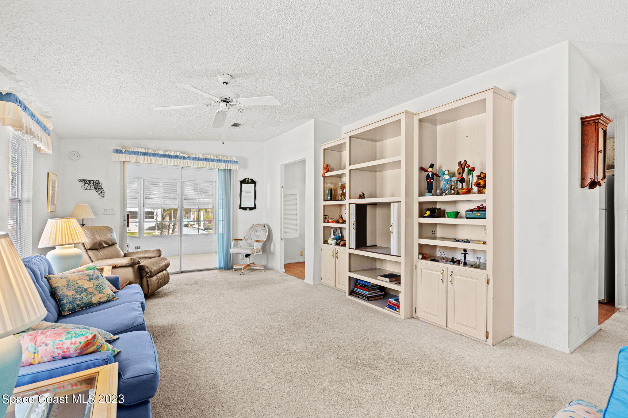 701 Gladiolus Drive Barefoot Bay, FL 32976 - Photo 4 of 19 a living room with furniture and white walls