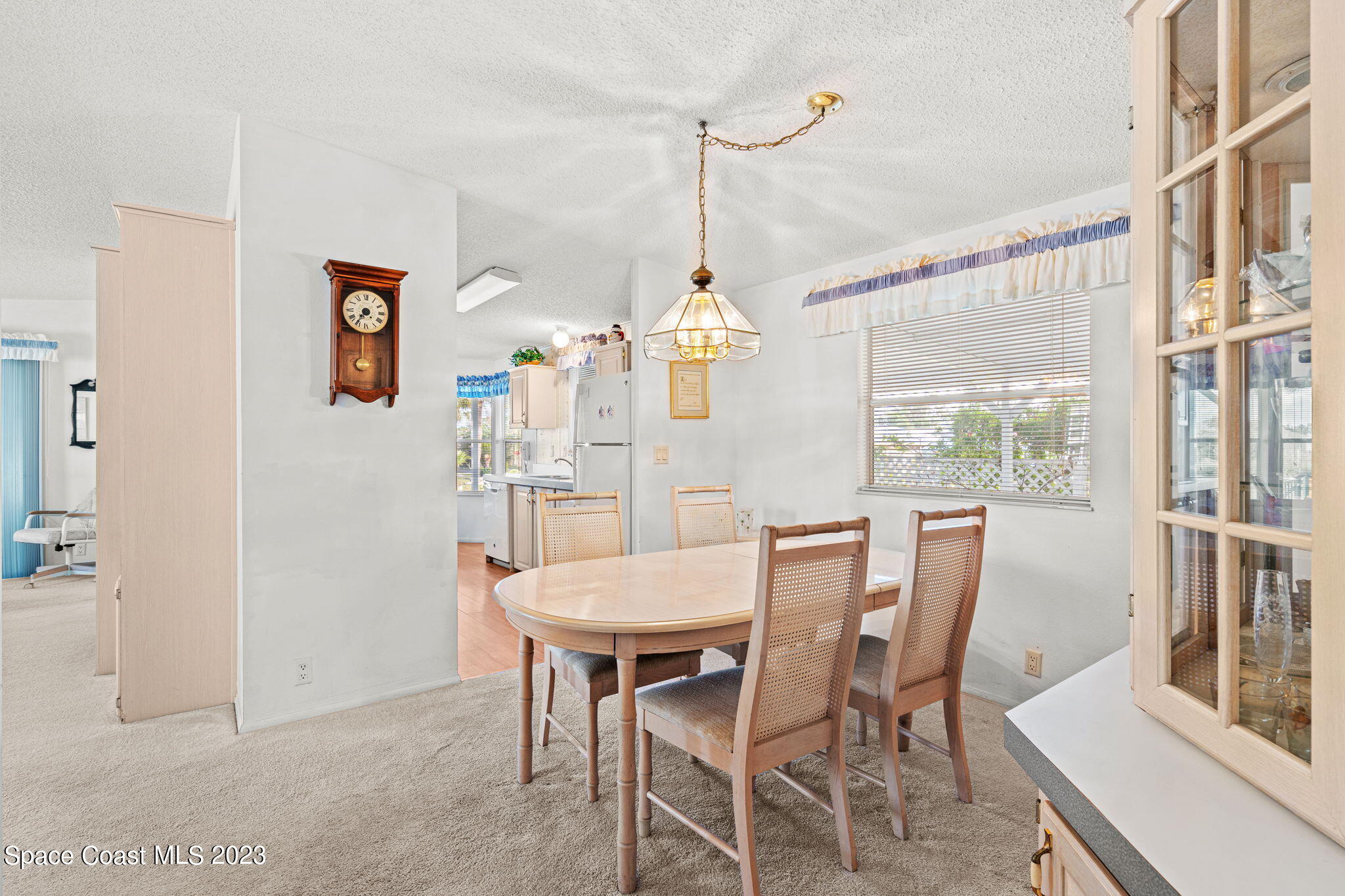 701 Gladiolus Drive Barefoot Bay, FL 32976 - Photo 5 of 19 a view of a dining room with furniture window and outside view