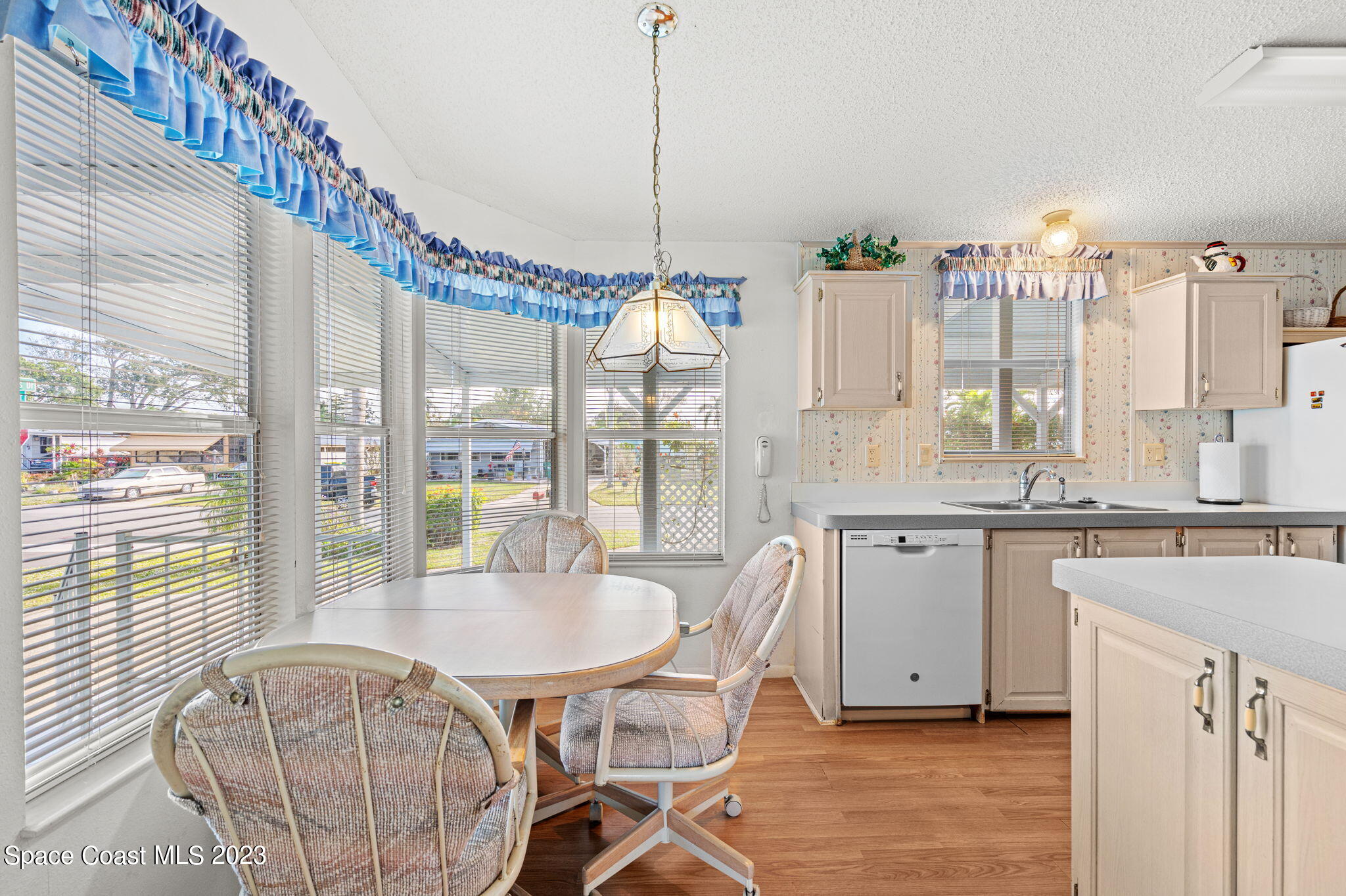 701 Gladiolus Drive Barefoot Bay, FL 32976 - Photo 8 of 19 a very nice looking dining room with a large window
