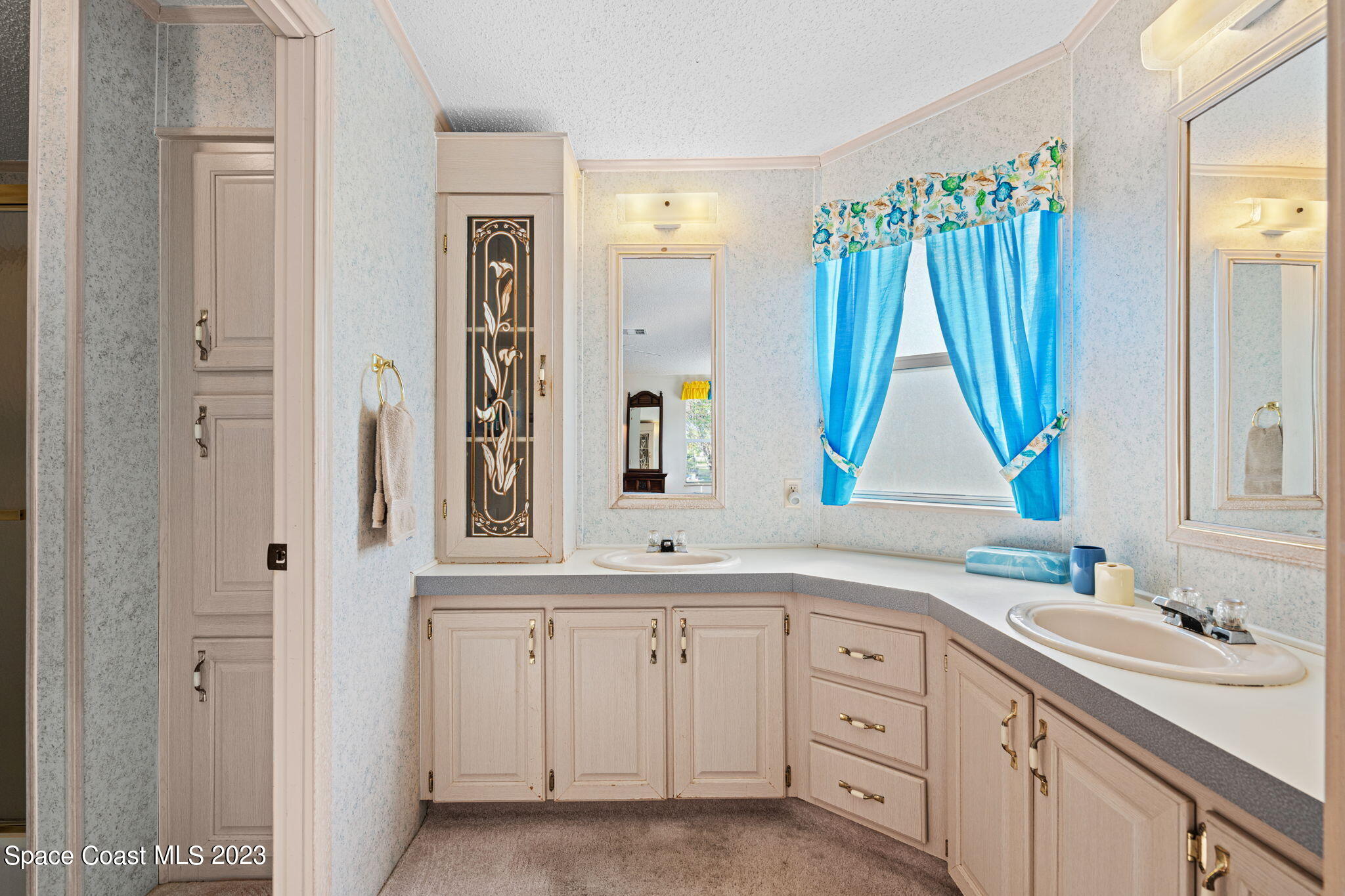 701 Gladiolus Drive Barefoot Bay, FL 32976 - Photo 10 of 19 a bathroom with a sink and a mirror