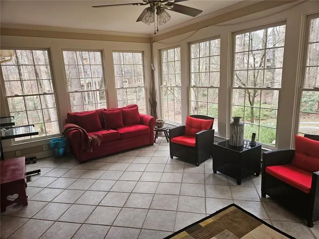 a living room with furniture and a floor to ceiling window