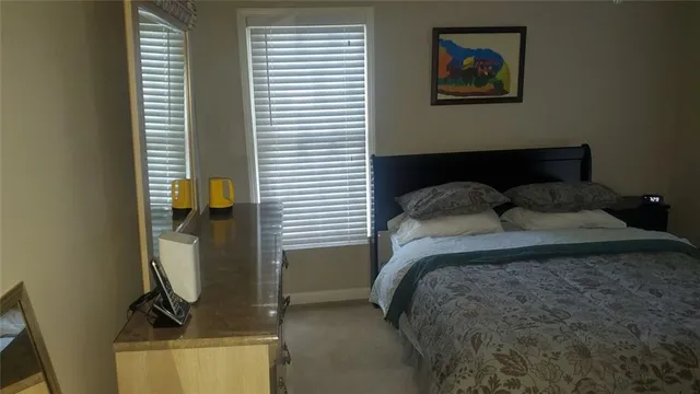 a bedroom with a bed and the view of bathroom