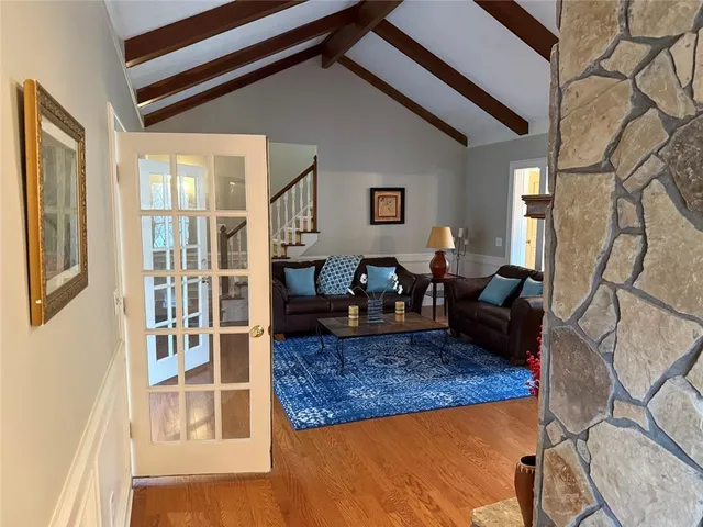 a living room with furniture a rug and a large window