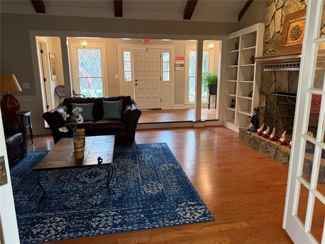 a living room with furniture rug and a floor to ceiling window