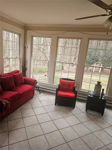 a living room with furniture and a floor to ceiling window