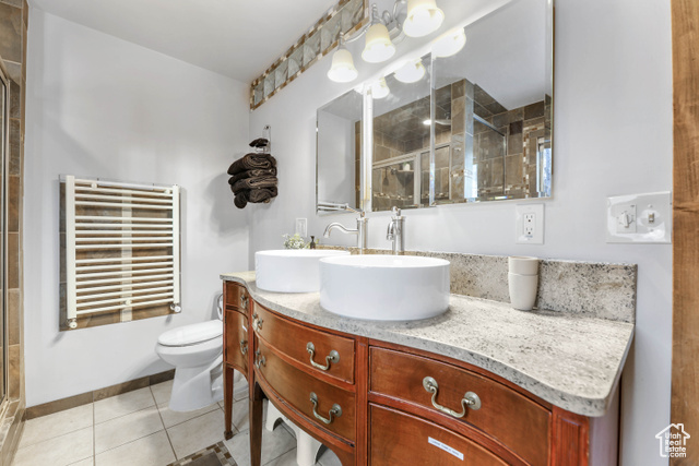 2029 West Tollgate Road Coalville, UT 84017 - Photo 23 of 43 Full bath featuring radiator heating unit, a shower stall, vanity, and light tile patterned floors