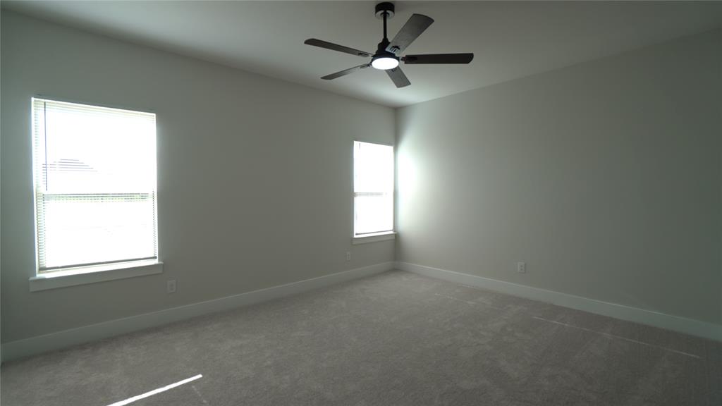1374 Chisos Way Forney, TX 75126 - Photo 13 of 25 an empty room with windows and chandelier fan