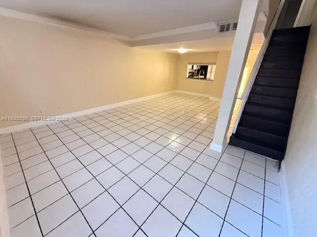 a view of an empty room and stairs