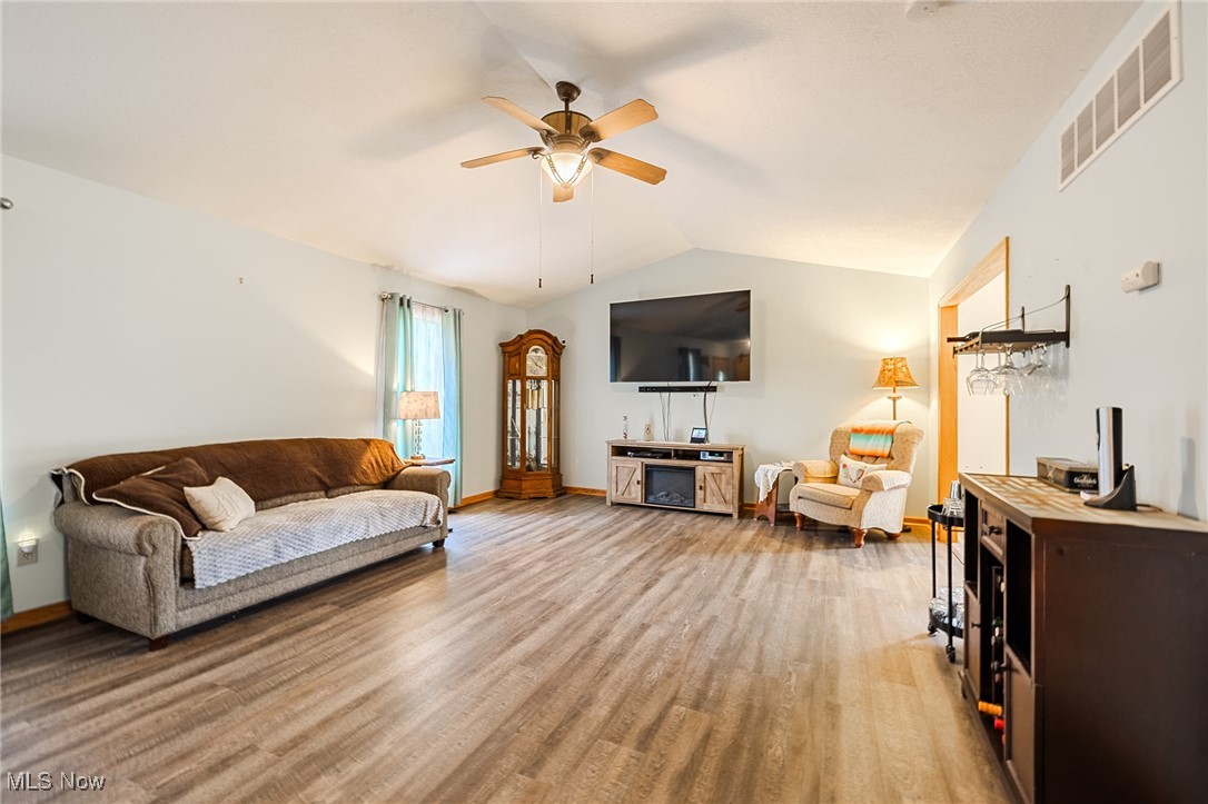 5691 Callahan Road Rome, OH 44085 - Photo 25 of 45 Living room with light wood-style floors, a ceiling fan, and lofted ceiling