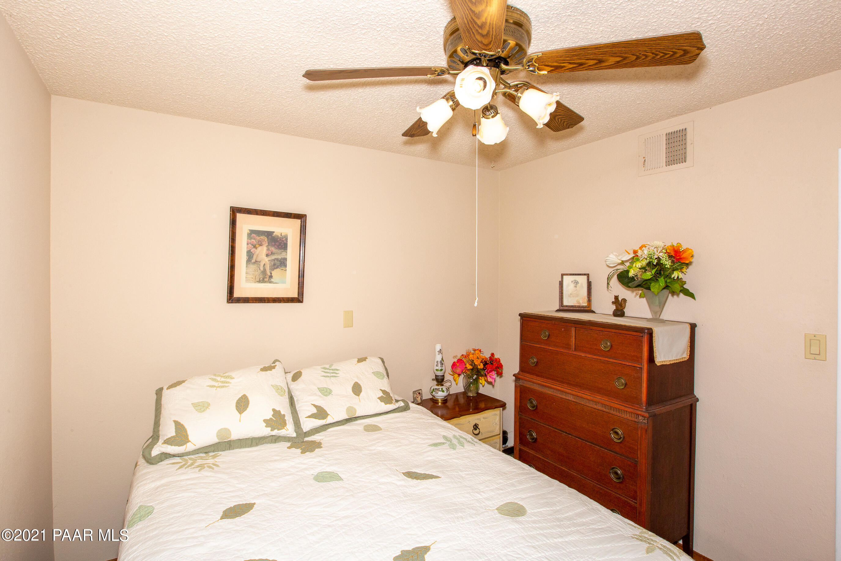 11991 Rawhide Ridge Dewey, AZ 86327 - Photo 16 of 29 a bedroom with a bed and a dresser