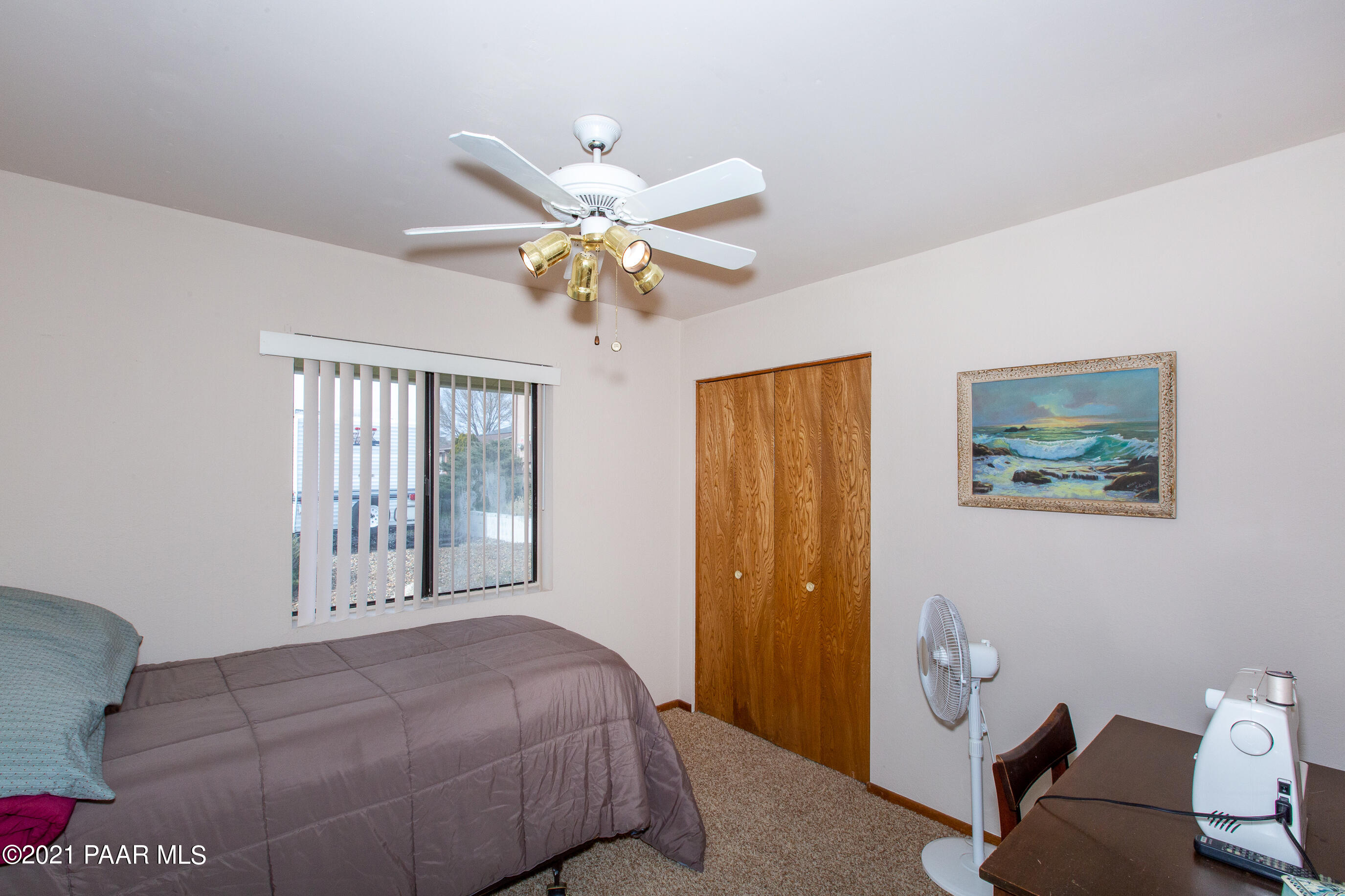 11991 Rawhide Ridge Dewey, AZ 86327 - Photo 23 of 29 a bedroom with a bed and a chandelier