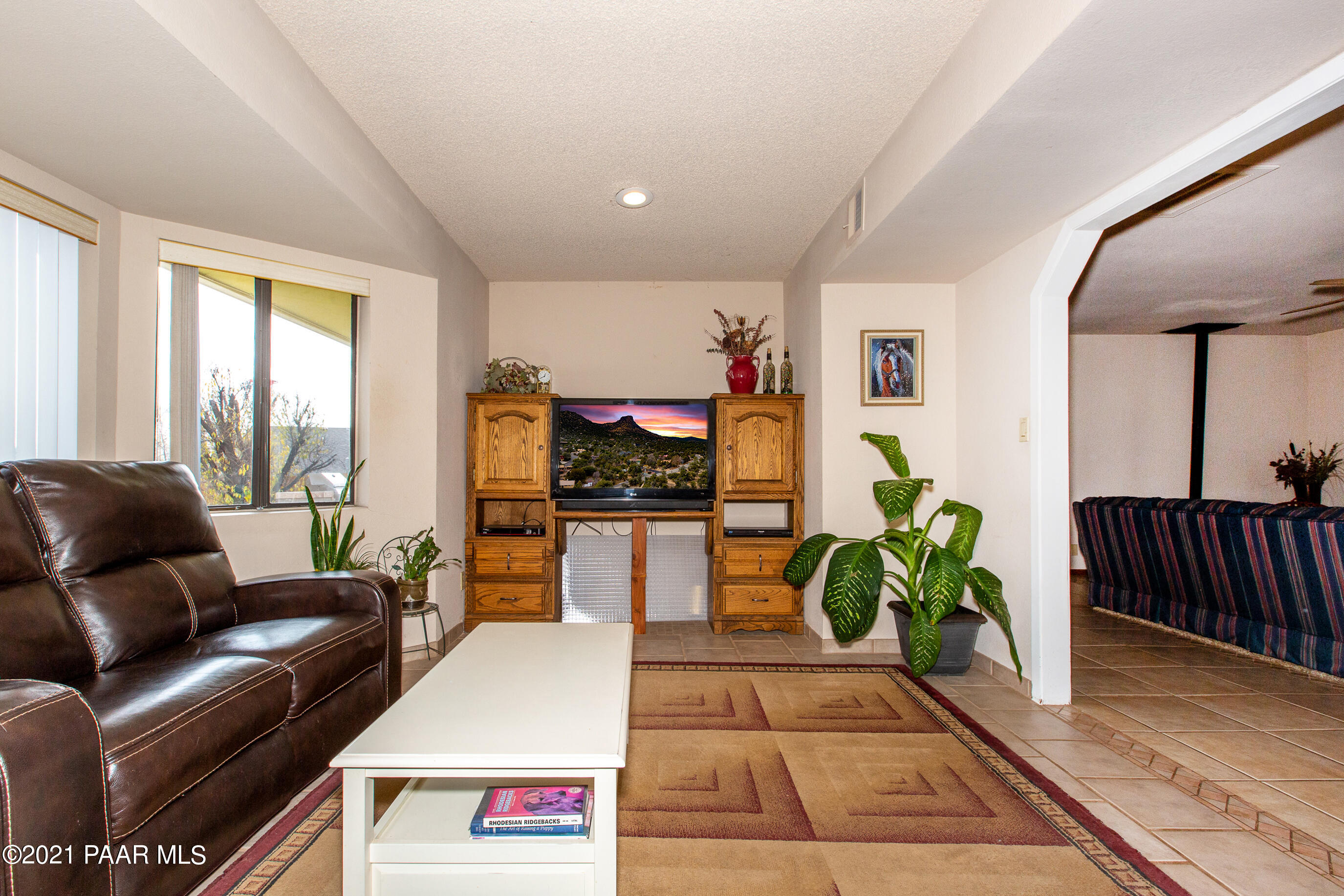 11991 Rawhide Ridge Dewey, AZ 86327 - Photo 4 of 29 a living room with furniture and a flat screen tv