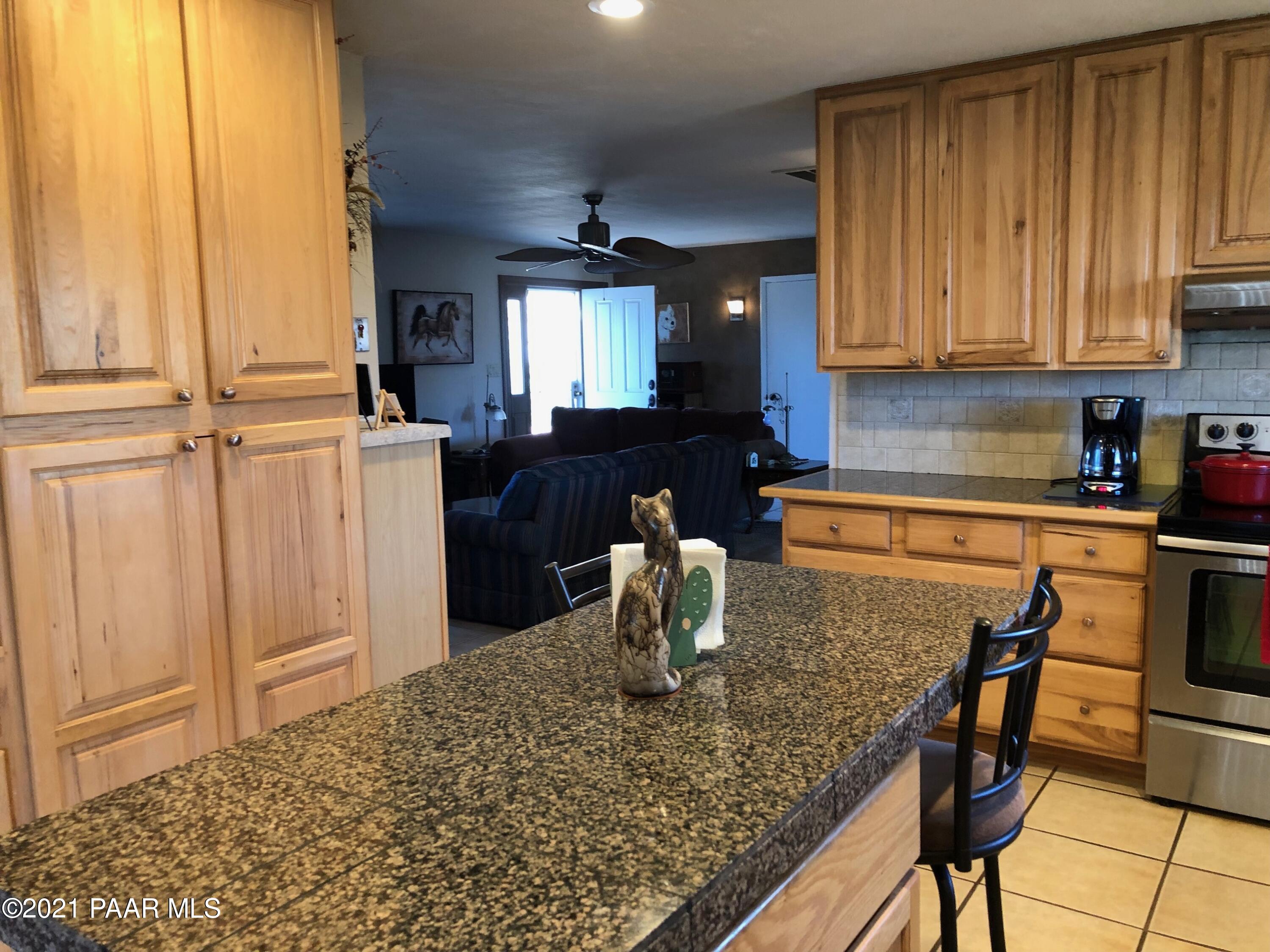 11991 Rawhide Ridge Dewey, AZ 86327 - Photo 7 of 29 a kitchen with a table chairs and microwave