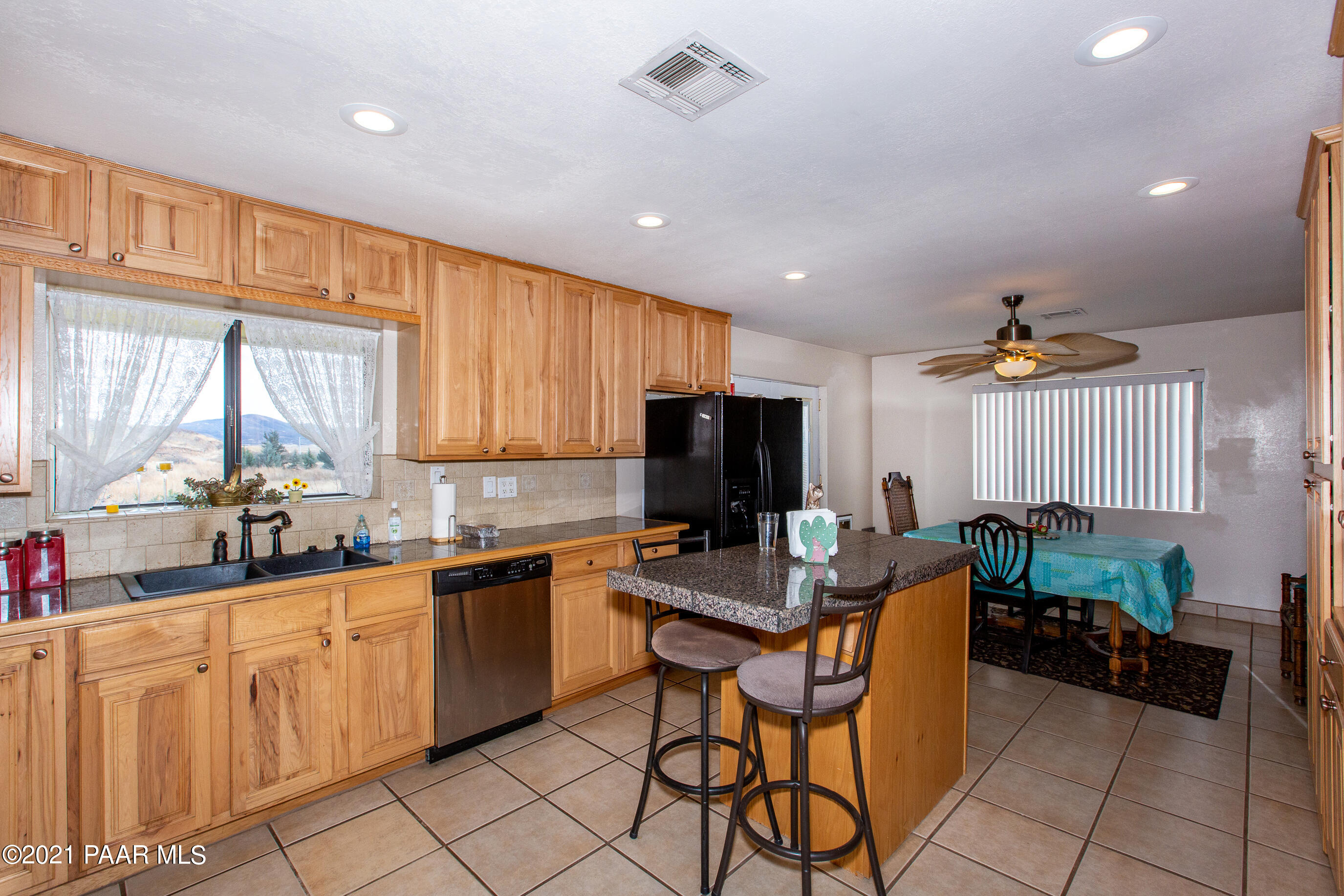 11991 Rawhide Ridge Dewey, AZ 86327 - Photo 8 of 29 a kitchen with stainless steel appliances kitchen island granite countertop a sink and cabinets