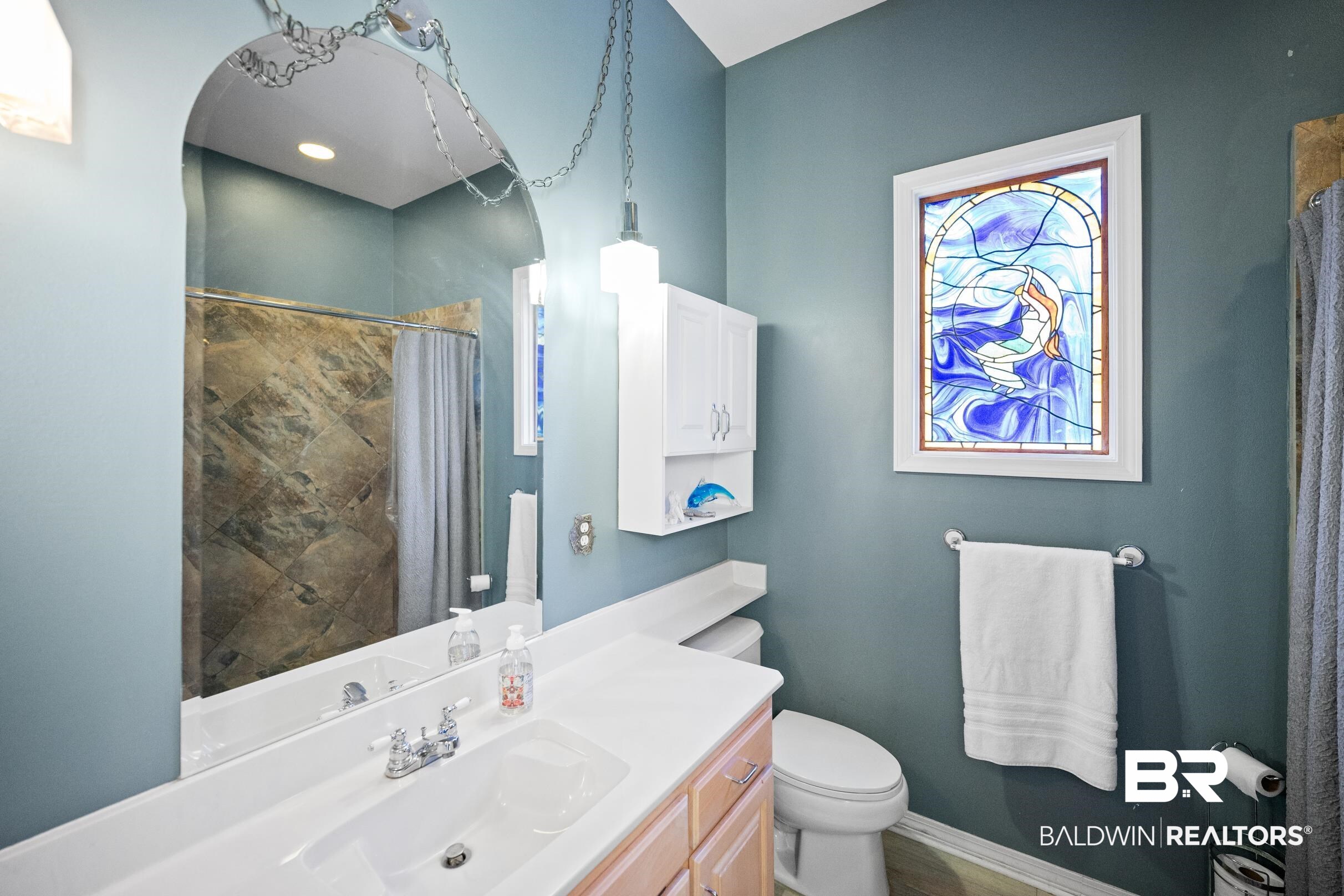 8585 Bay Harbor Road Elberta, AL 36530 - Photo 27 of 51 Bathroom with vanity and a shower with shower curtain