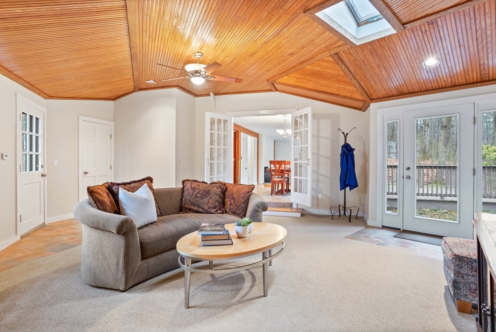 103 Newtown Road Acton, MA 01720 - Photo 12 of 42 a living room with furniture a chandelier and a dining table