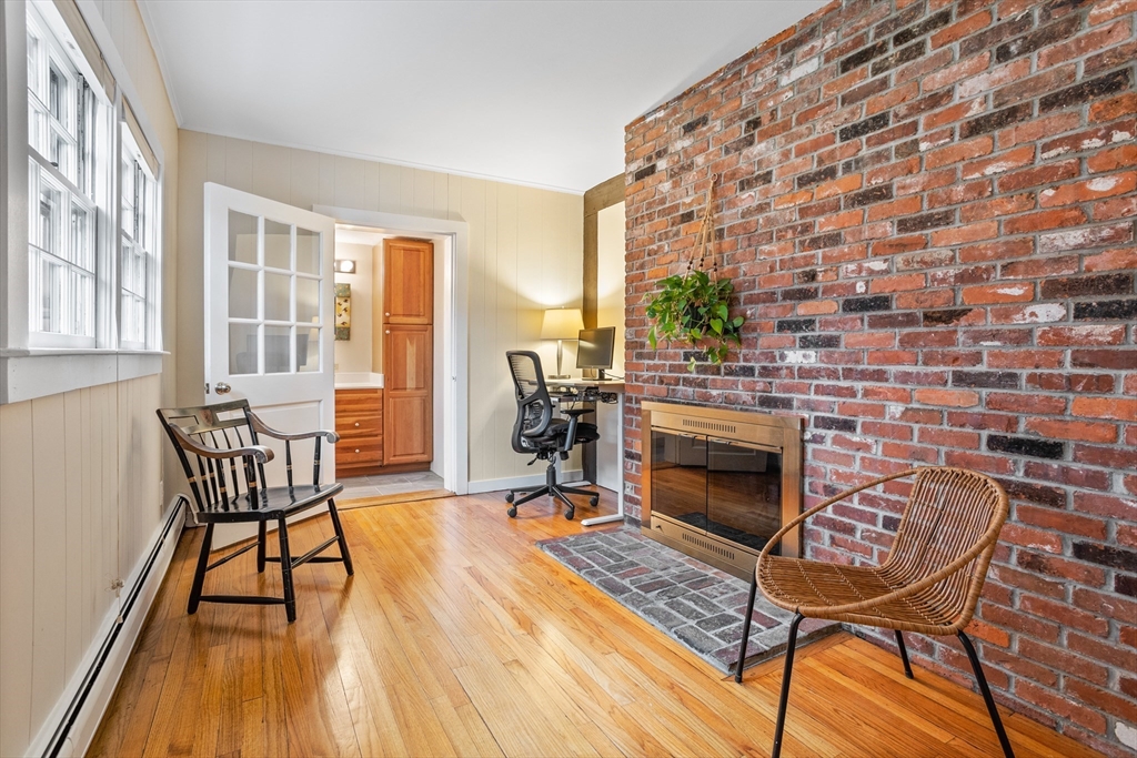 103 Newtown Road Acton, MA 01720 - Photo 15 of 42 a living room with a fireplace and furniture