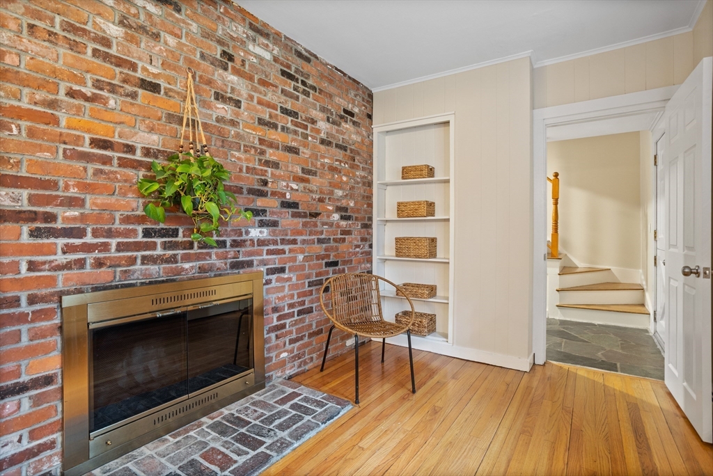 103 Newtown Road Acton, MA 01720 - Photo 16 of 42 a living room with a fireplace and a wooden floor