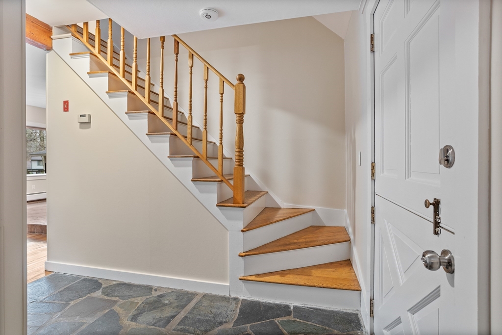 103 Newtown Road Acton, MA 01720 - Photo 19 of 42 a view of a hallway with staircase