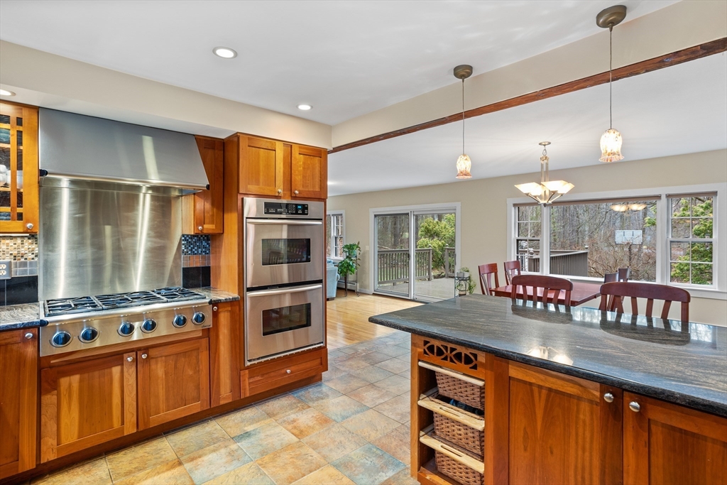 103 Newtown Road Acton, MA 01720 - Photo 2 of 42 a kitchen with stainless steel appliances granite countertop a stove and more cabinets