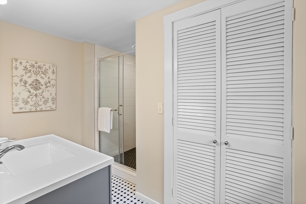 103 Newtown Road Acton, MA 01720 - Photo 23 of 42 a bathroom with a sink and a mirror