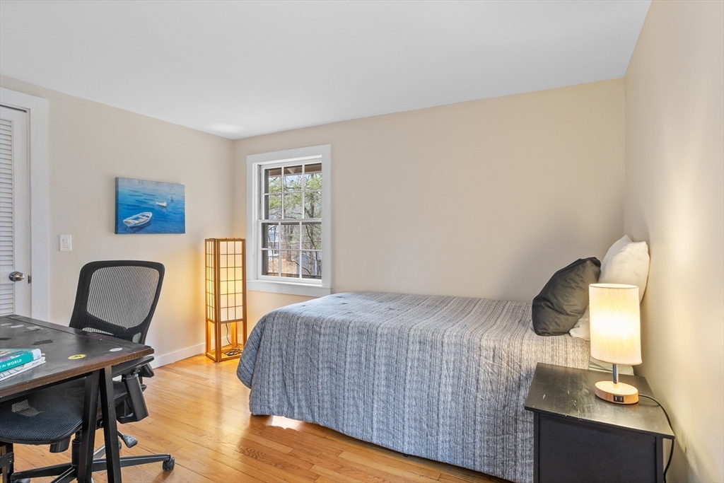 103 Newtown Road Acton, MA 01720 - Photo 28 of 42 a bedroom with a bed and a desk next to a window